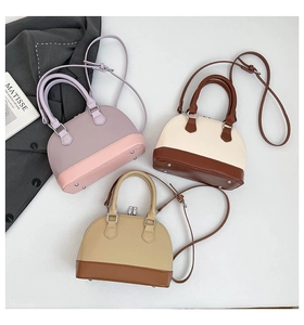 Three leather shell bags in pastel and brown colors with handles and straps