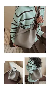 Detailed views of grey lychee texture leather bucket bag with top handle and shoulder strap