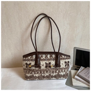 Detail of plush tote bag with vintage geometric pattern and leather shoulder handles