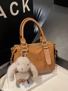 Vintage brown woven pillow bag with double handles and a cute rabbit charm accessory