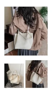 Close-up of cream lychee texture tote bag with double handles and slim shoulder strap