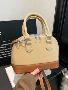 Retro two-tone beige and brown shell bag with top handles and adjustable strap