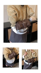 Close-up of a dark brown vintage shoulder bag with a large silver buckle and soft texture