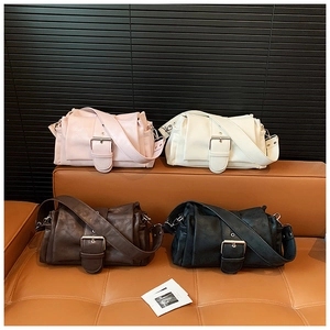 Detailed display of vintage pleated shoulder bags in pink, white, brown and black colors