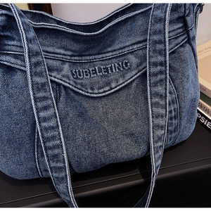 Detailed view of dark blue denim tote bag with high-quality 3D logo embroidery