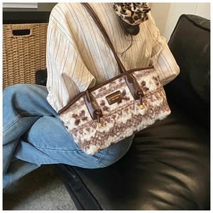 Detail of plush tote bag with brown animal pattern and leather logo patch