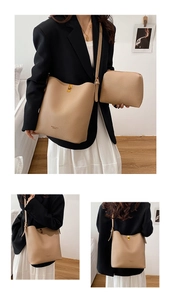 Detail view of apricot pebbled leather bucket bag featuring adjustable strap and metal clasp