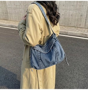 Close-up of vintage blue denim tote bag with 3D embossed SUPERLINE logo lettering