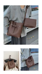 Detail view of dark brown pebbled bucket bag and pouch set for versatile commuting