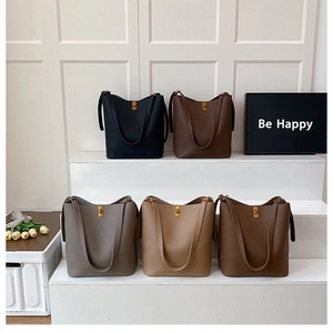 Detail view of large-capacity bucket bags in five colors with golden turn-lock buckles