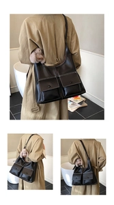 Detail of black Hobo tote with double front pockets and white contrast stitching details