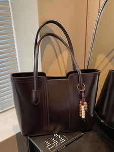 Large dark brown shiny faux leather tote bag with elegant beaded charm and shoulder straps