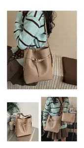 Detail view of khaki bucket bag with pebbled leather texture and matching inner pouch