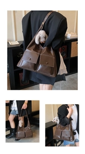 Detail of dark brown tote bag featuring dual front pockets and white contrast stitching