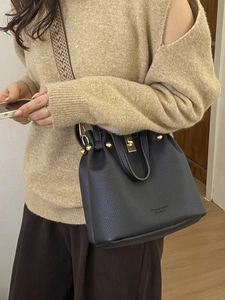 Classic black leather bucket bag with gold lock and vintage woven wide shoulder strap