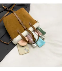 Top view of brown suede bucket bag with faux fur trim showing spacious interior capacity