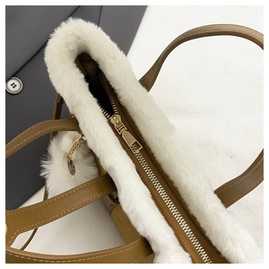 Close-up of khaki tote bag with white faux fur trim and premium metal zipper detail
