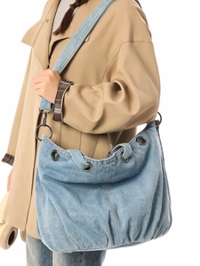 Vintage light blue denim hobo tote bag with bronze metal eyelets and wide strap