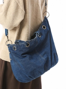 Large vintage denim tote bag for women with silver metal eyelets and a shoulder strap