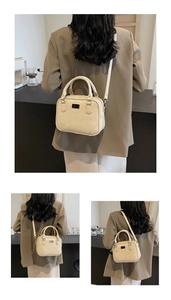 Detailed view of cream PU leather crossbody bag with metal accents and sleek top handle