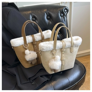 Detail of elegant tote bags with faux fur trim and plush pom-poms on leather seats