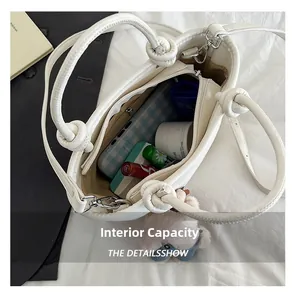 Interior view of white leather tote bag showing spacious storage with zipper pocket