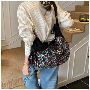 Close-up of a black fabric hobo bag featuring colorful sequins and wide shoulder strap