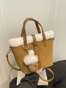 Elegant brown suede handbag with white faux fur trim and adjustable shoulder strap