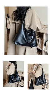 Detail of a large black leather hobo bag with a bow accent and a square logo patch