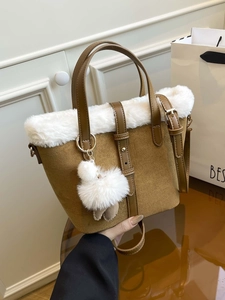 Brown faux suede bucket bag with white faux fur trim and gold hardware detailing