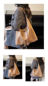 Close-up of a brown PU leather tote bag with a decorative bow and soft texture