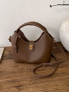 Brown lychee leather hobo handbag with gold buckle and adjustable shoulder strap