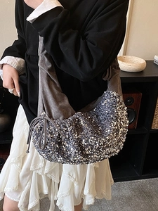 Fashionable silver sequined shoulder bag with pleated velvet strap and drawstring detail