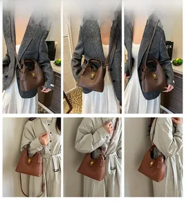 Detailed close-up of brown litchi grain leather bucket bags with metallic twist locks