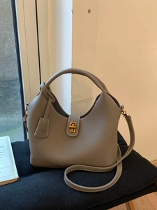 Chic grey litchi grain leather bucket bag with top handle and gold turn-lock closure