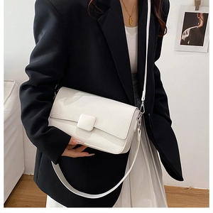 Chic white faux leather flap bag styled with black blazer and pleated skirt