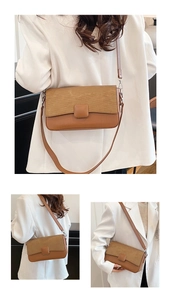 Detail view of brown patchwork crossbody bag with corduroy flap and faux leather strap