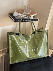 Large dark green transparent tote bag with white lettering for stylish commuting