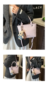 Detailed close-up of pink bucket bag with a cute bear plush keychain accessory