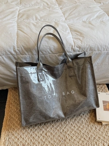 Stylish grey glossy PVC tote bag with white TOTE BAG print for minimalist daily commute