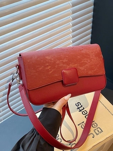 Chic red shoulder bag with textured flap and silver hardware for women's daily commute