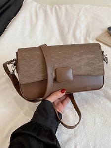 Minimalist brown crossbody box bag with textured flap for daily commute and casual style