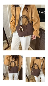 Détail d'un sac vintage marron foncé avec cuir gaufré vertical et breloque à glands perlés