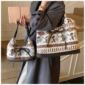 Detail of vintage jacquard plush tote bag with bow tie decoration and soft texture