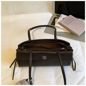 Interior detail of vintage brown leather handbag showing multi-compartment lining and zipper
