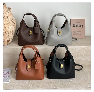 Detail of four litchi grain bucket bags with gold hardware and removable shoulder straps