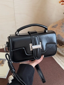 Glossy black crossbody handbag with silver buckle and braided strap detail