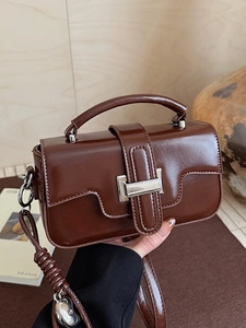 Brown vintage leather crossbody bag with silver heart charm and top handle for women