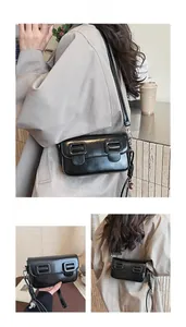 Detail of a black glossy leather saddle bag with square buckles and woven rope charm