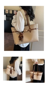 Detail of beige tote bag with brown leather trim and cute plush bear charm accessory